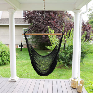 Bliss Hammocks 40-inch Black Island Rope Hammock Chair hanging on a front porch.