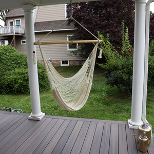 Bliss Hammocks 40-inch White Island Rope Hammock Chair hanging on a front porch.