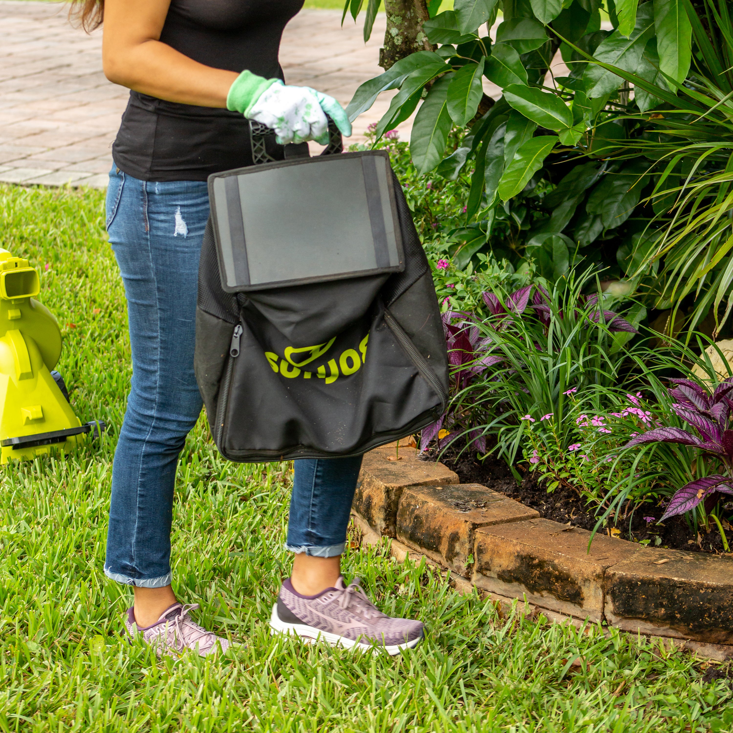 Person holding the collection bag for the Sun Joe 48-volt Cordless Outdoor Garden Vacuum/Mulcher Kit.