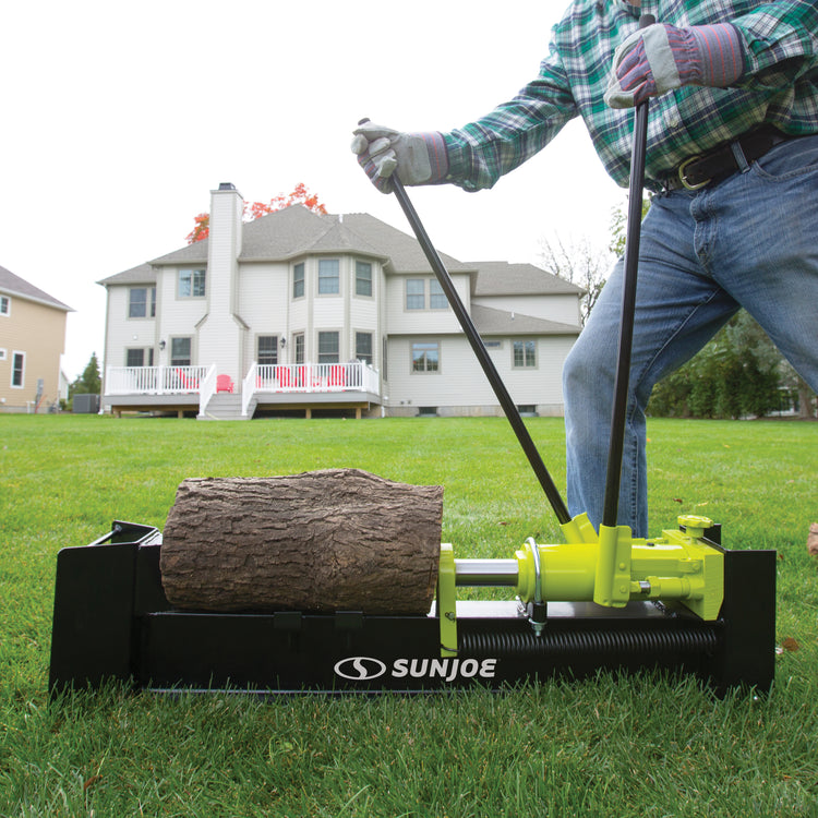 Person splitting a log outside with the Sun Joe 10-ton Hydraulic Log Splitter .
