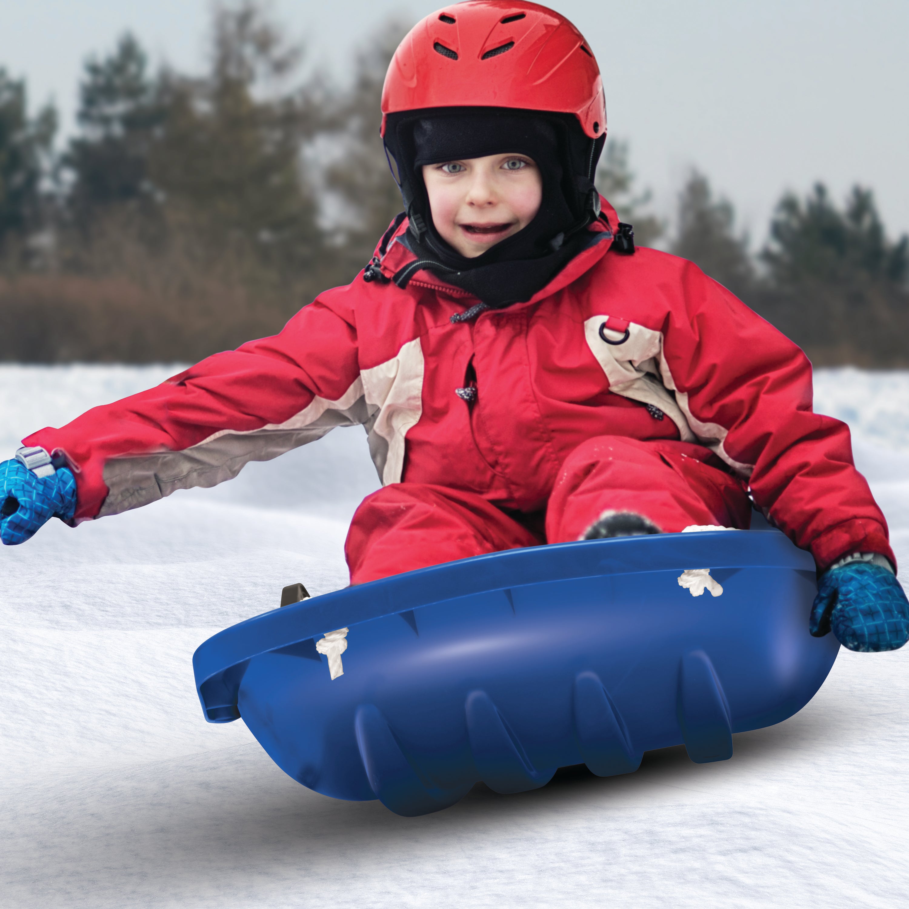 Kid riding in the Snow Joe blue-colored kids snow sled.