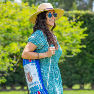 woman carrying bliss hammocks fabric hanging chair in included travel bag