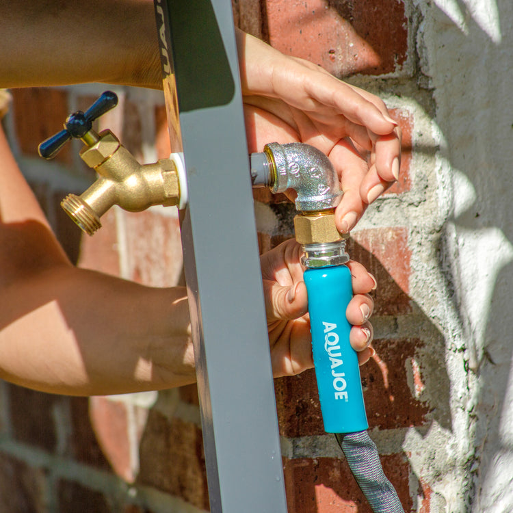 Aqua Joe 75-foot fiberjacket garden hose being attached to a faucet.