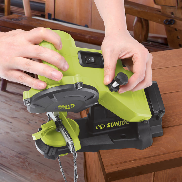 Person adjusting the Sun Joe 24-Volt Cordless Mountable Chainsaw Sharpener.