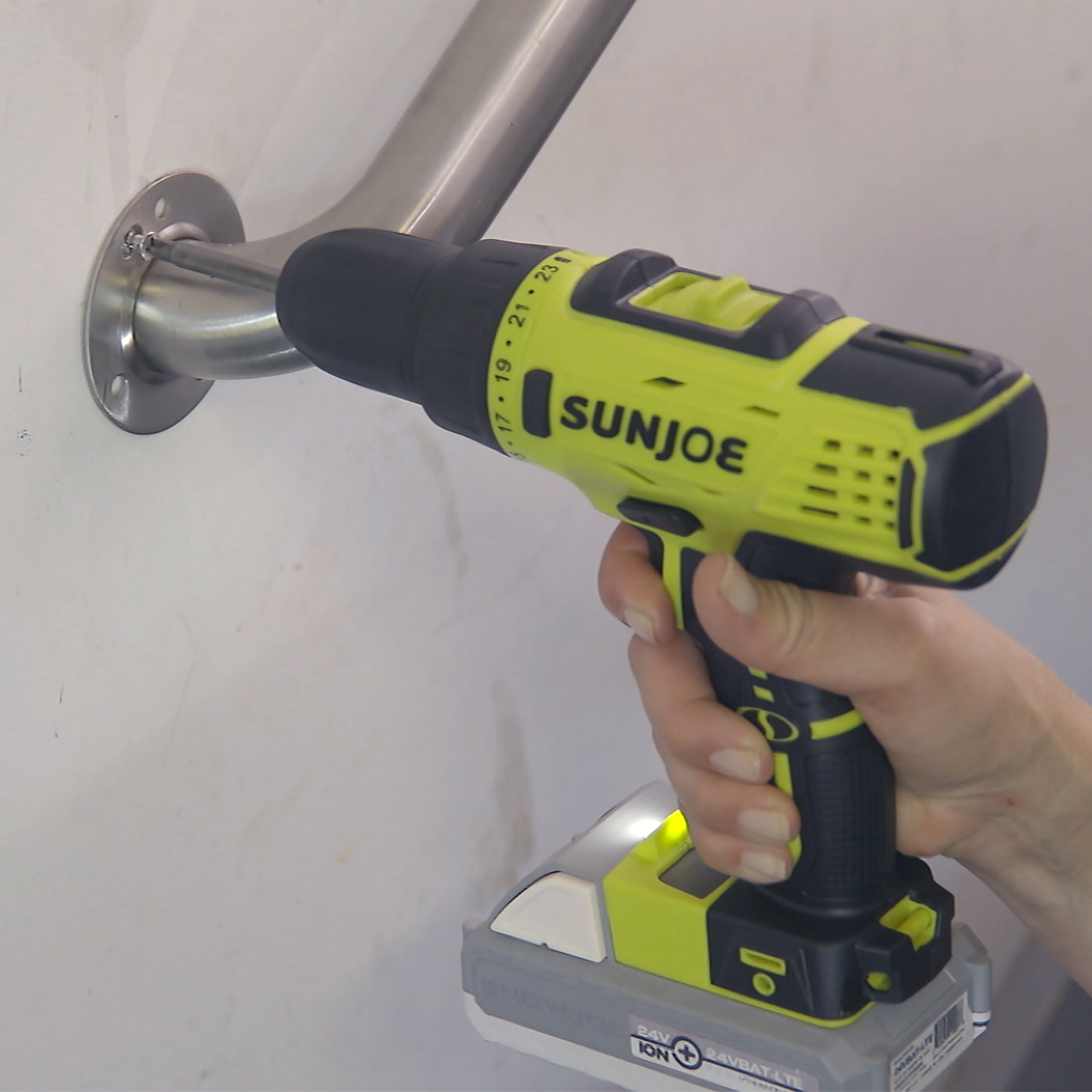 Person using the Sun Joe 24-Volt Cordless Drill Driver to install a railing.