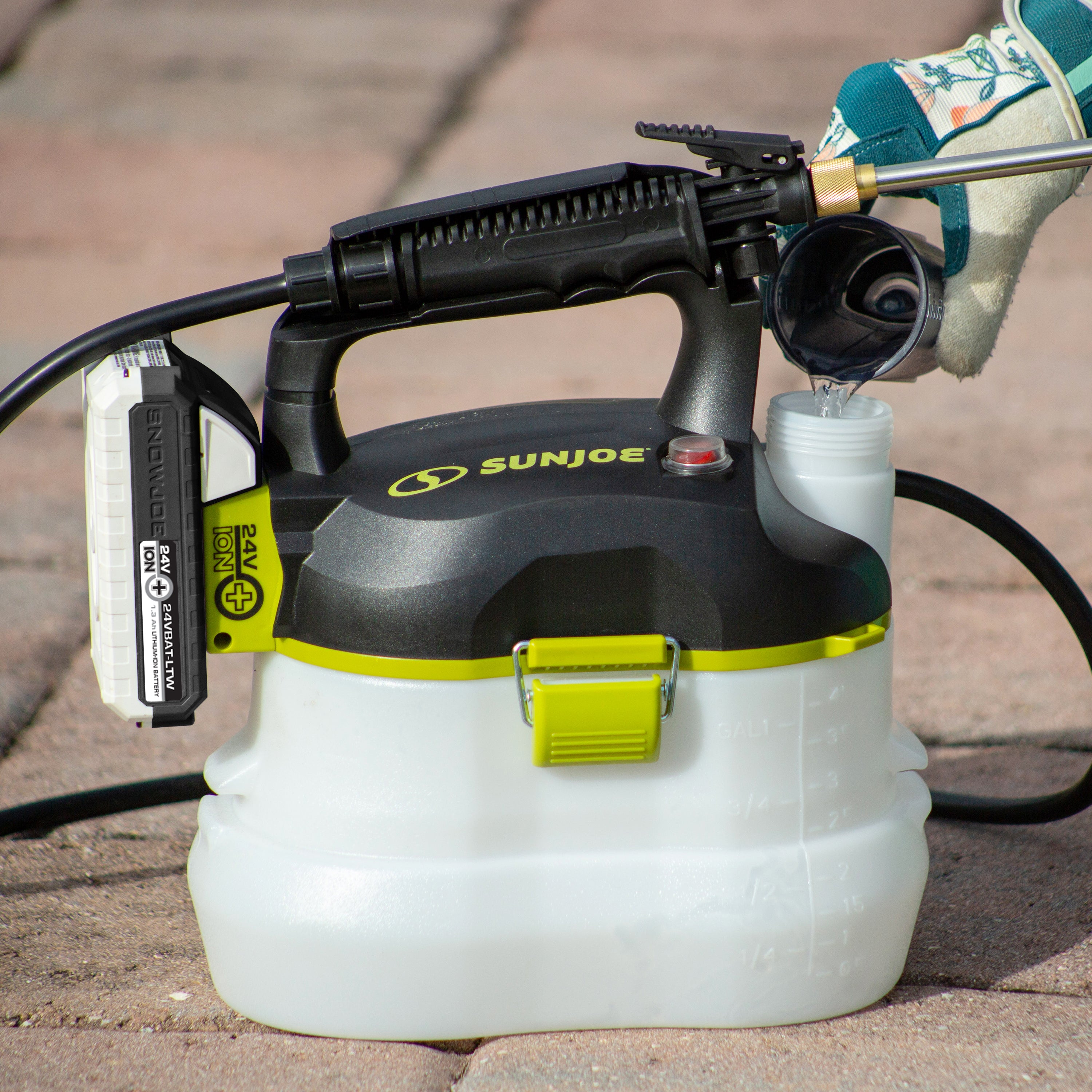 Sun Joe 24-volt cordless Multi-Purpose Chemical Sprayer Kit sitting on paving stones.