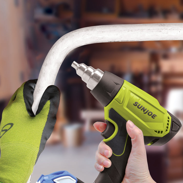 Person using the Sun Joe 24-volt cordless Heat Gun to make a tube malleable.