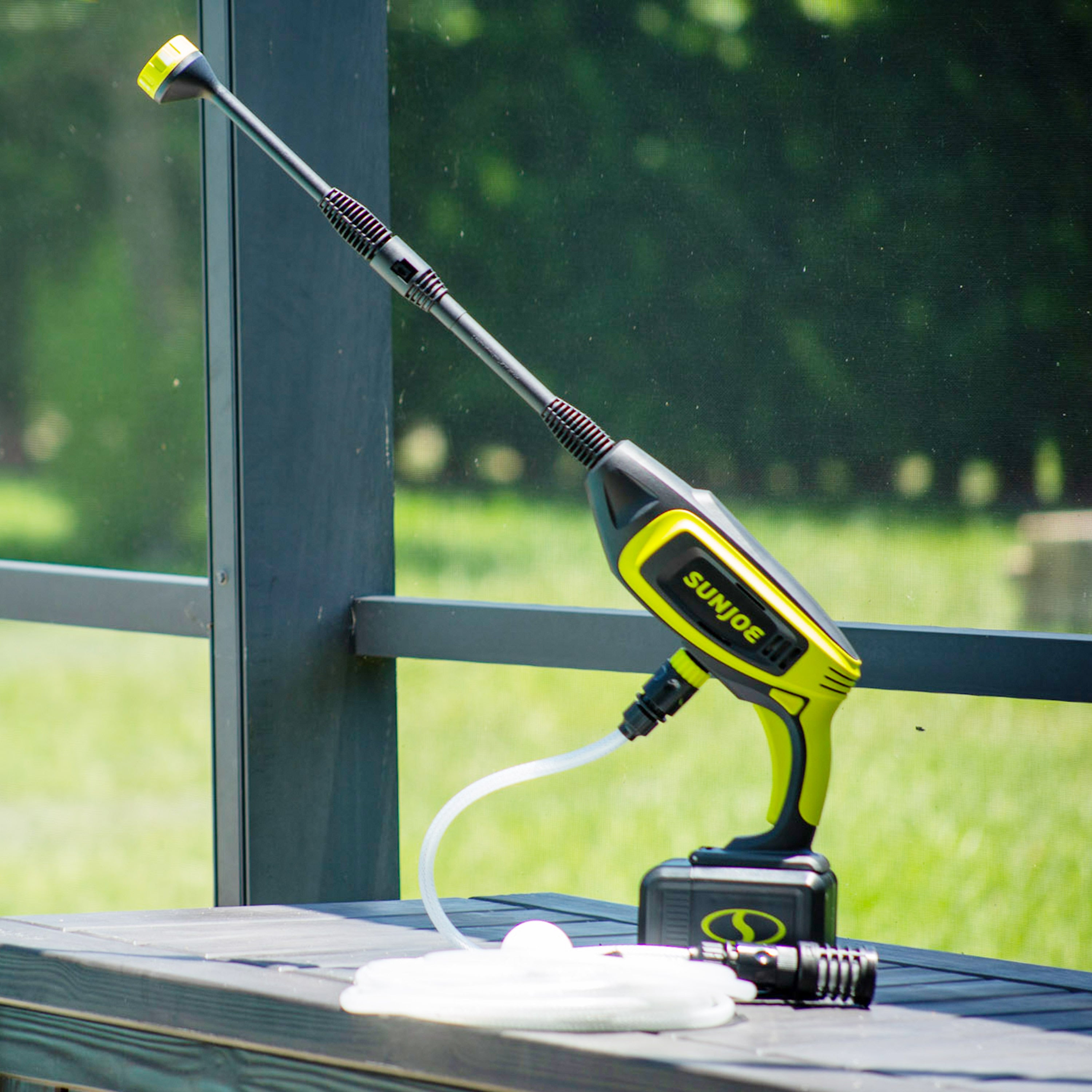 Sun Joe 24-Volt Cordless Power Cleaner outside with grass in the background.