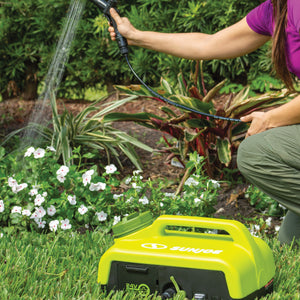 Person watering flowers with a Sun Joe 24-volt cordless portable shower spray washer.