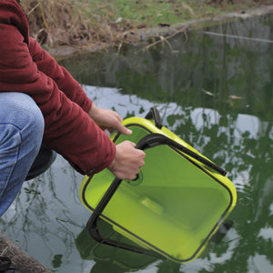 Person filling up the detachable bucket with water for the Sun Joe 48-volt Cordless Portable Pressure Washer Kit.