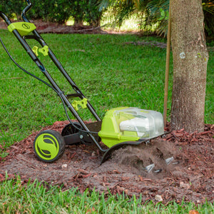 Sun Joe 48-volt Cordless 14-inch Garden Tiller/Cultivator Kit being used to till dirt around a tree.