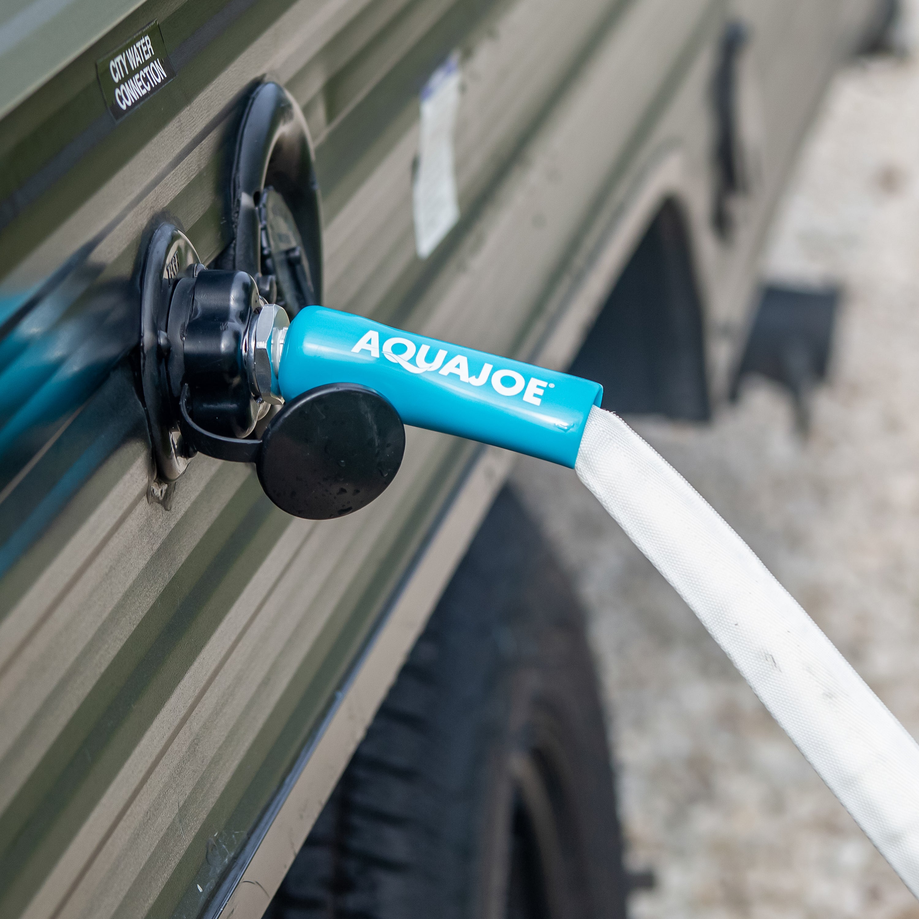 Aqua Joe 50-foot Fiberjacket RV hose connected to an RV.