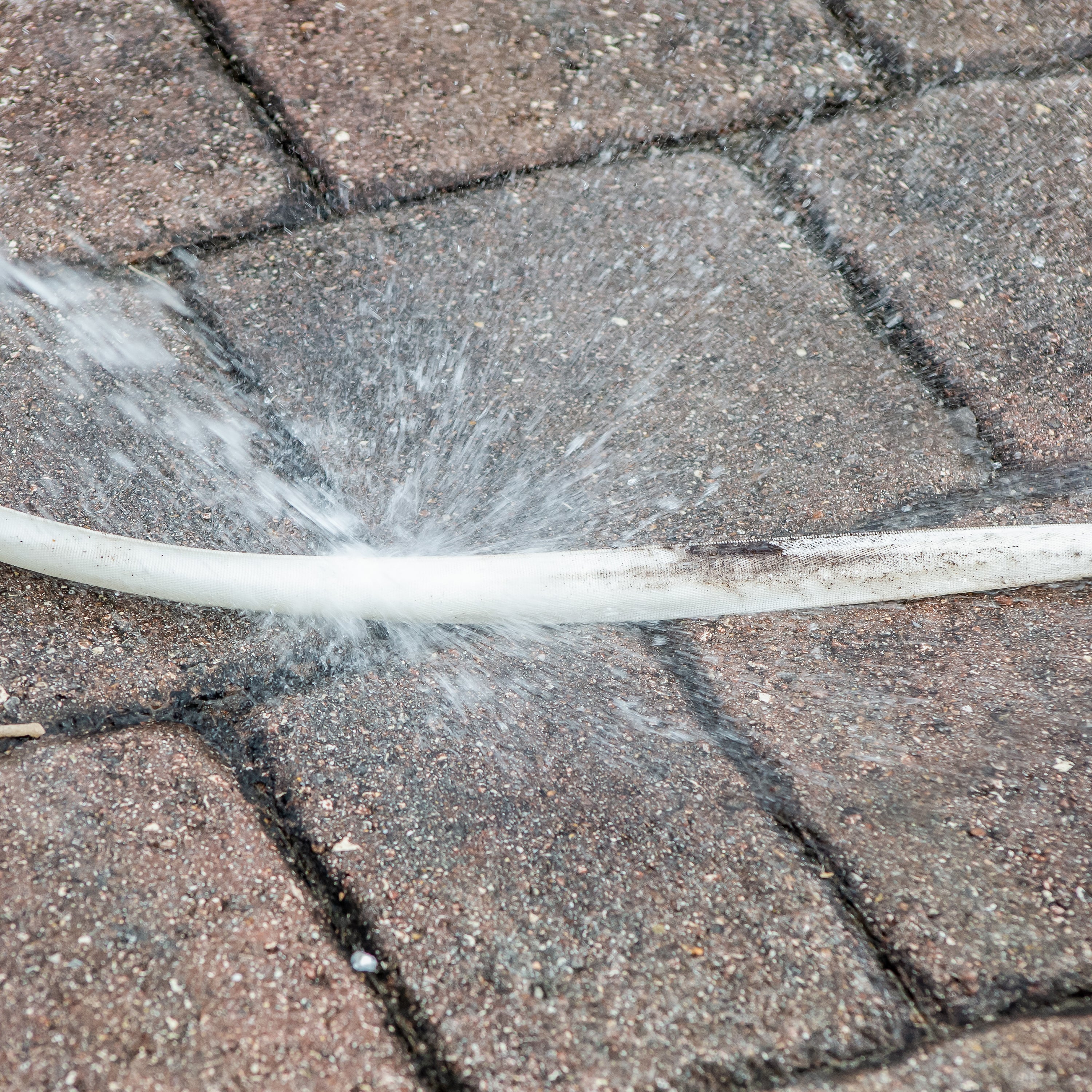 Aqua Joe 50-foot Fiberjacket RV hose being cleaned.