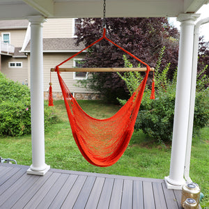 Bliss Hammocks 40-inch Orange Island Rope Hammock Chair hanging on a front porch.