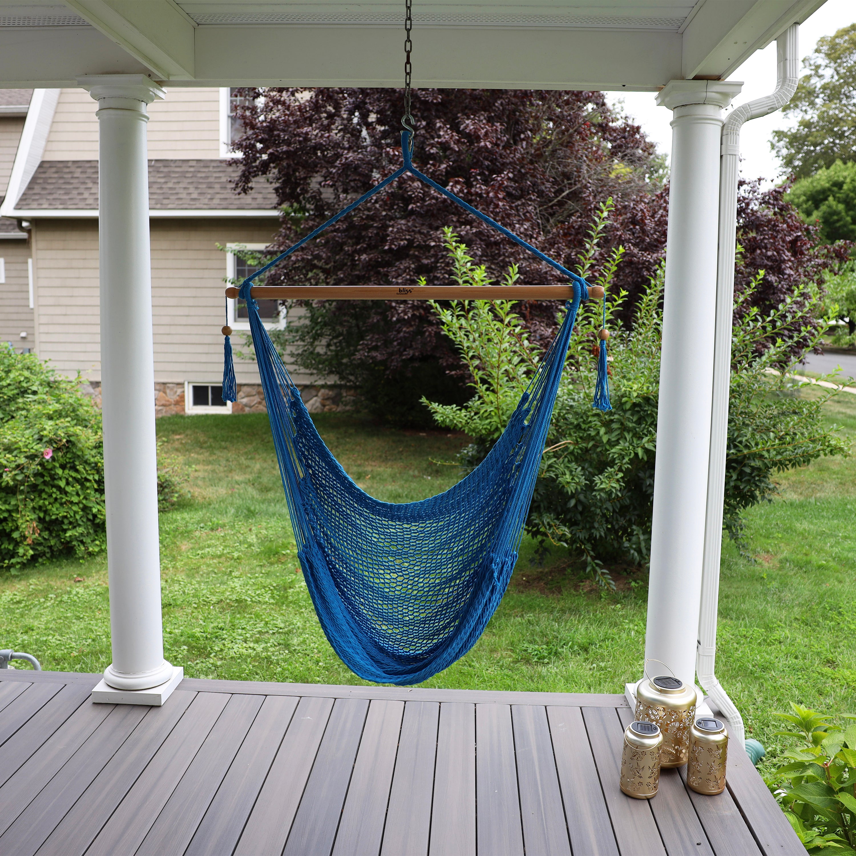 Bliss Hammocks 40-inch Light Blue Island Rope Hammock Chair hanging on a front porch.