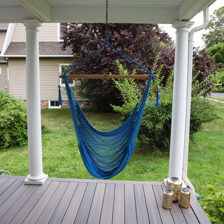 Bliss Hammocks 40-inch Light Blue Island Rope Hammock Chair hanging on a front porch.