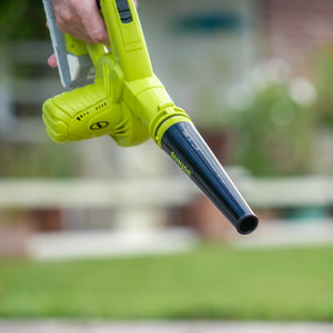 Person using the Sun Joe 24-volt cordless workshop blower with a 2.0-Ah lithium-ion battery attached outside.