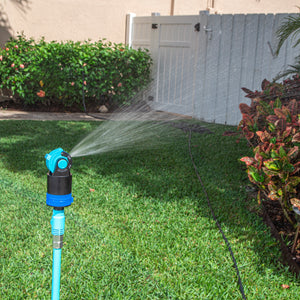 Aqua Joe Indestructible Turbo Drive 360 Degree Telescoping Tripod Lawn and Garden Sprinkler and Mister watering a lawn.