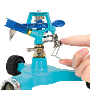 Person adjusting the trip lever on the Aqua Joe 6-inch wheeled base Indestructible Zinc Impulse 360 Degree Sprinkler.