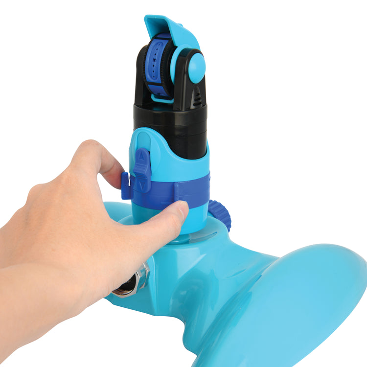 Person adjusting the 360-degree rotation on the Aqua Joe 4-Pattern Turbo Drive 360 Degree Sprinkler.