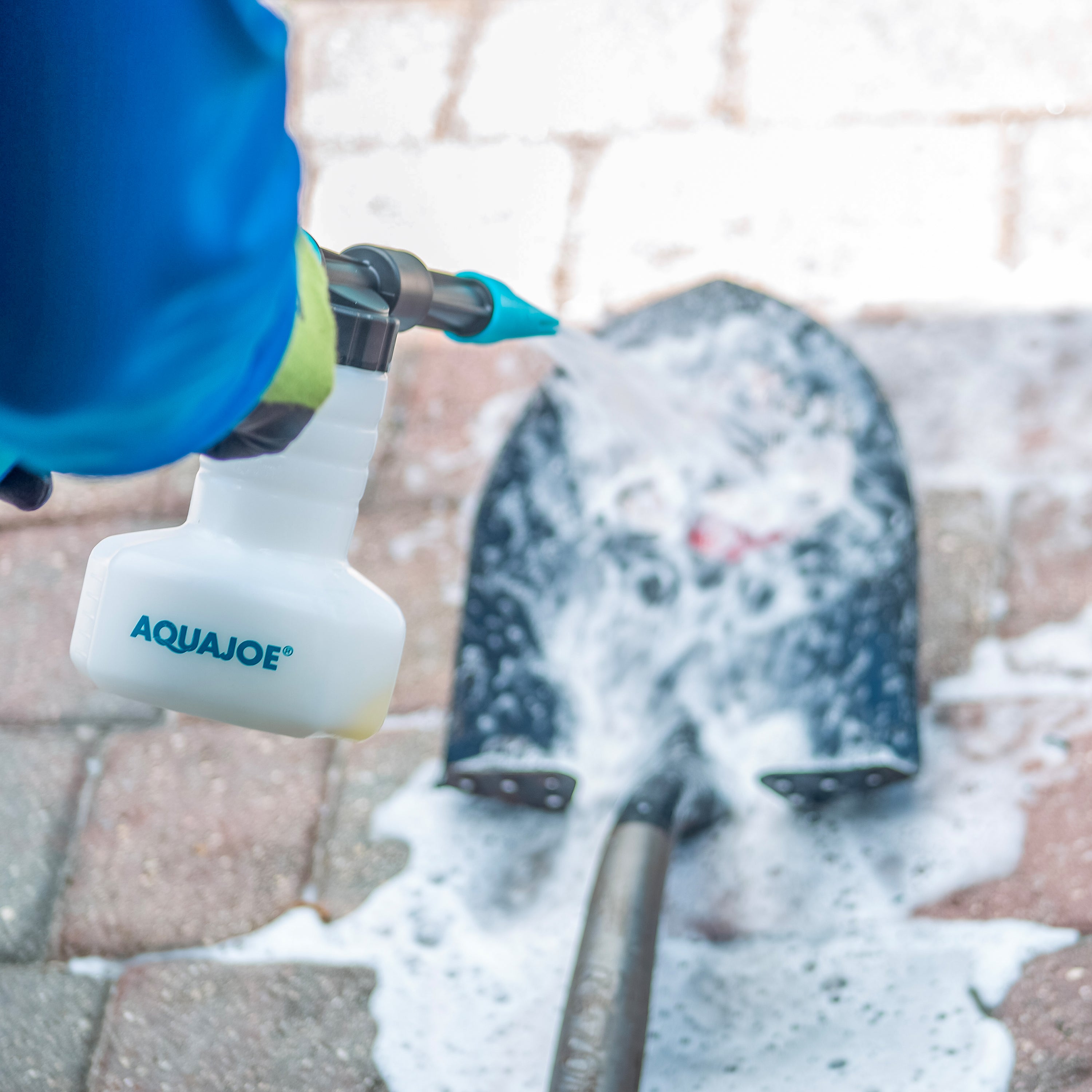 Aqua Joe 2-in-1 Hose-Powered Adjustable Foam Cannon Spray Gun Blaster being used to clean a shovel.