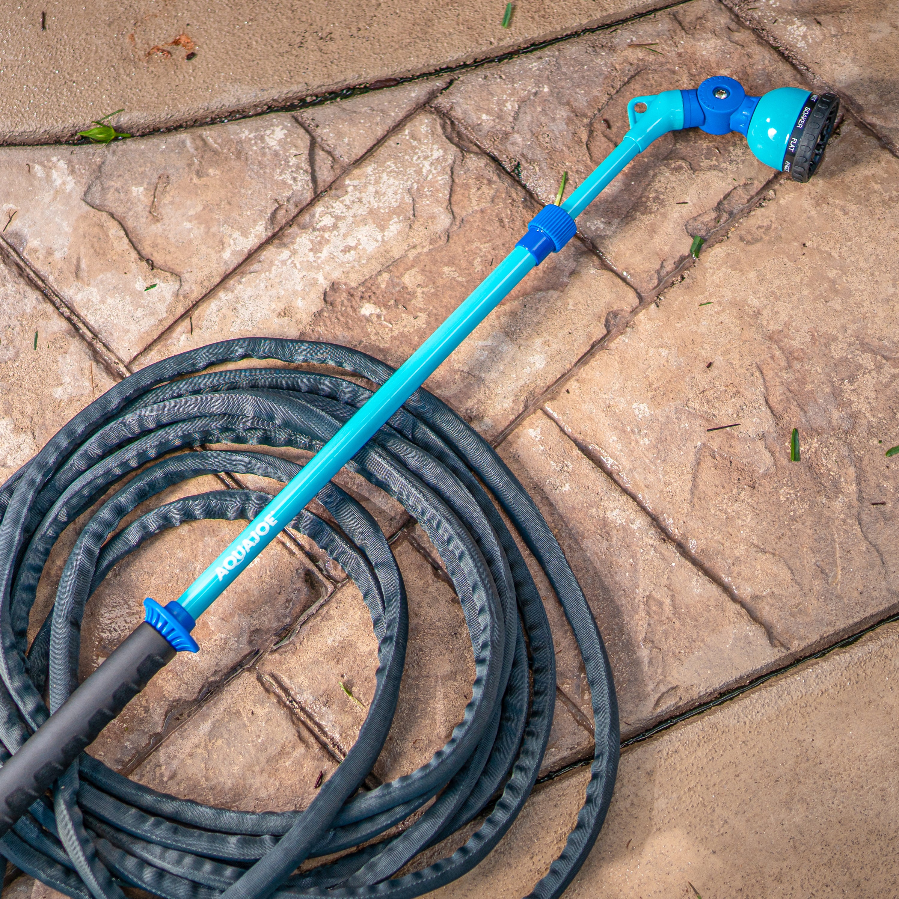 Aqua Joe 53-inch Telescoping Watering Wand connected to a hose on the ground.