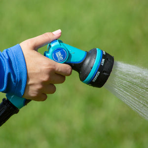 Close-up of the Aqua Joe Heavy Duty Indestructible Metal Multi Function Adjustable Hose Nozzle being sprayed.