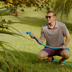 Man Using Aqua Joe Hybridflex Hose to water plant