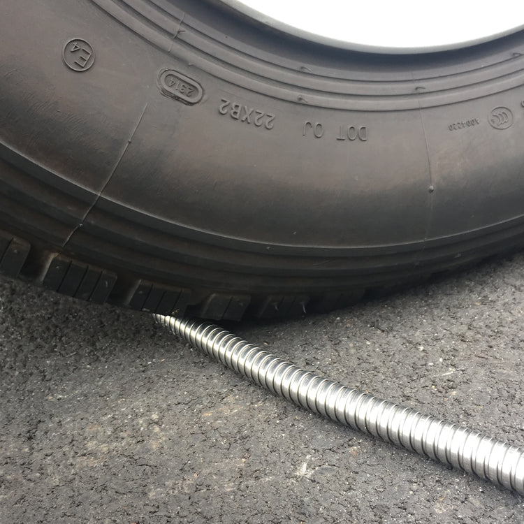 car tire running over aqua joe garden hose