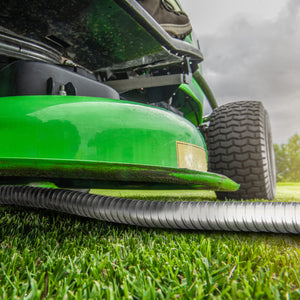 Lawn mower running over aqua joe metal garden hose