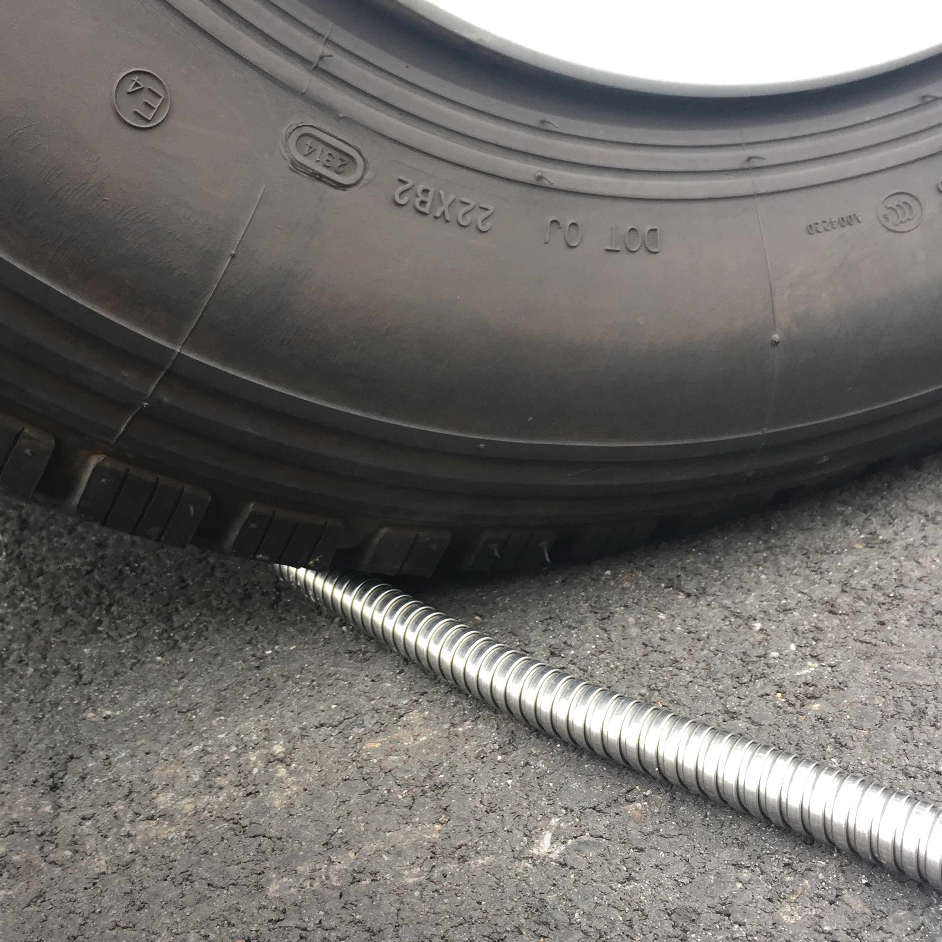 Aqua Joe Metal Garden Hose being run over by car tire