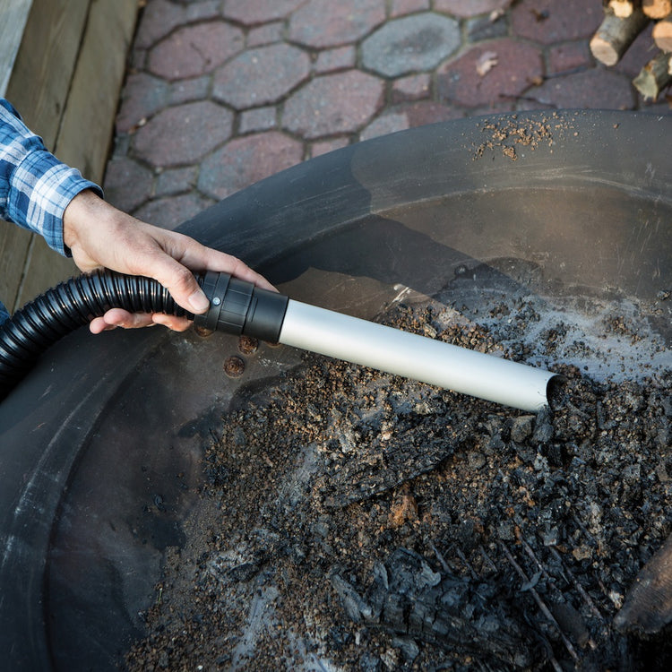 Snow Joe 5-amp 4.8 Gallon Ash Vacuum being used to suck ash out of a fire pit.