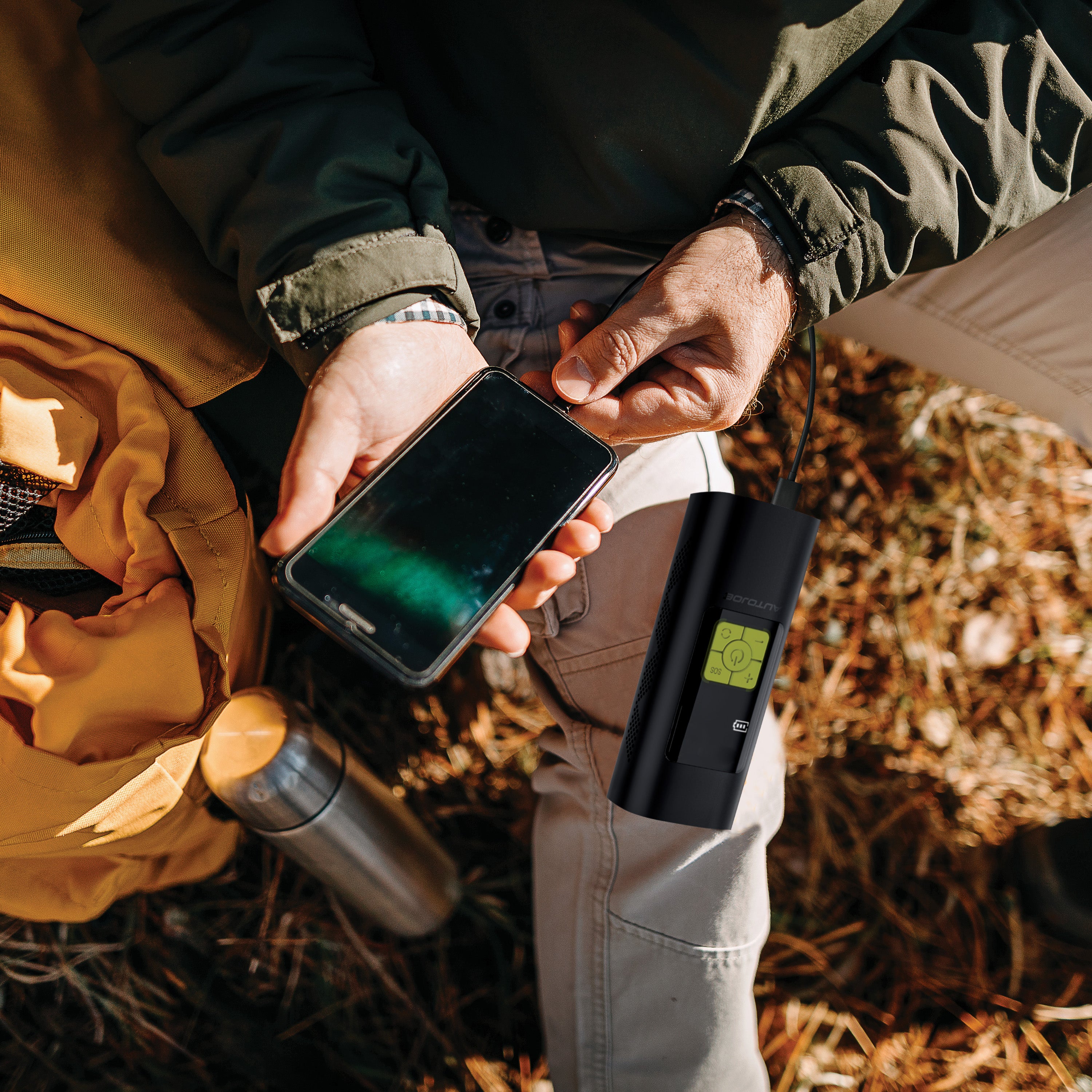 Sun Joe 140 PSI Ultra Compact Cordless Digital Air Pump Inflator and Power Bank being used to charge a cell phone.