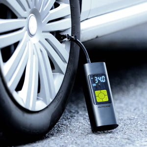 Cordless digital air pump inflator and power bank inflating a car tire.