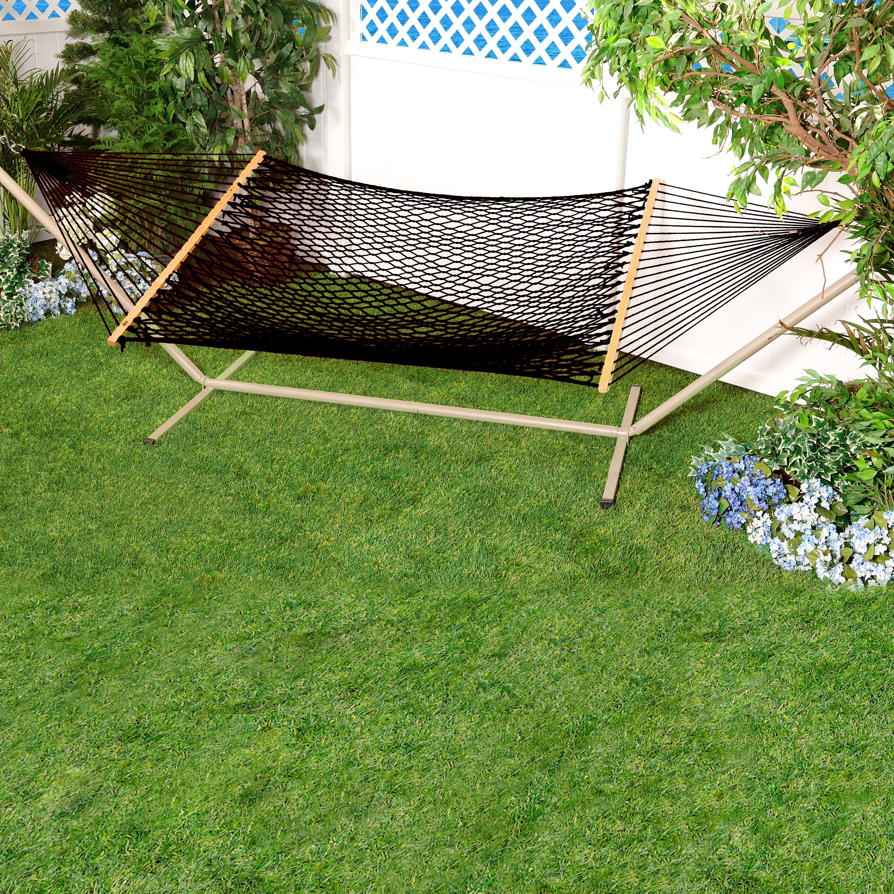 Bliss Hammocks 60-inch Wide Black Cotton Rope Hammock secured to a stand in a backyard.