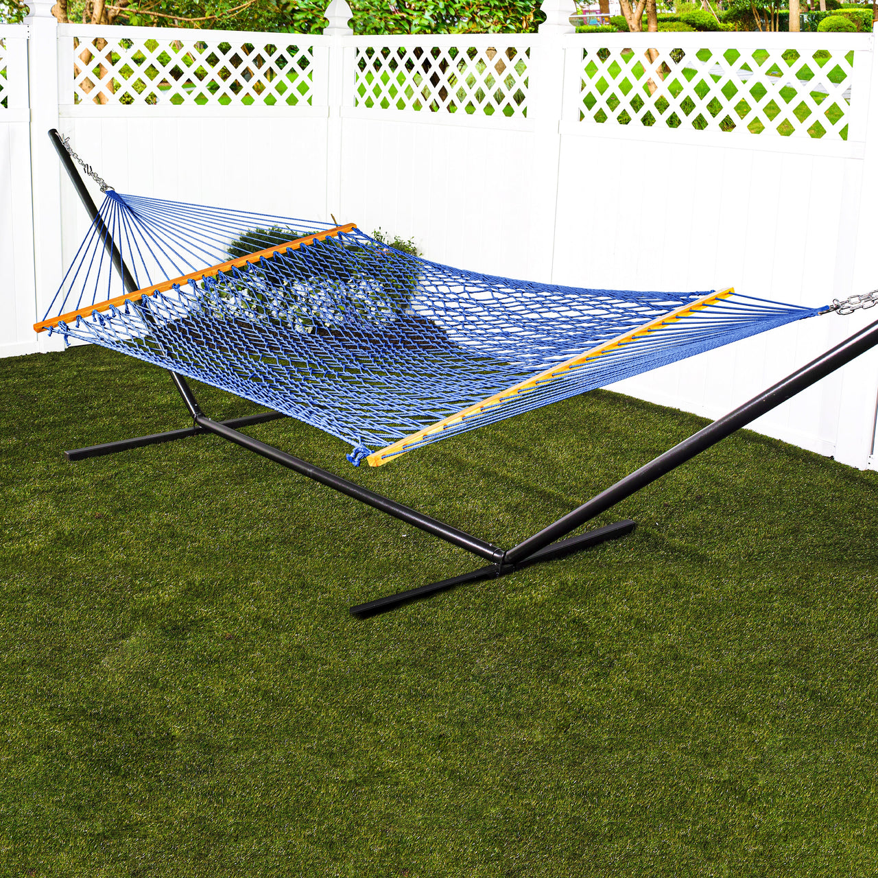Bliss Hammocks 60-inch Wide Blue Cotton Rope Hammock secured to a stand in a backyard.