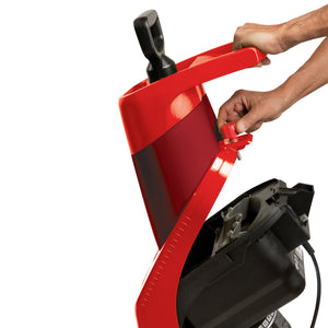 Person lifting up the top of the Sun Joe 15-amp Electric Wood Chipper in red to see inside.