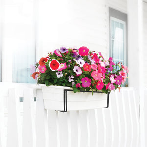 Sun Joe Deco Joe Adjustable Flower Box Holder in black holding flowers on the side of a railing.