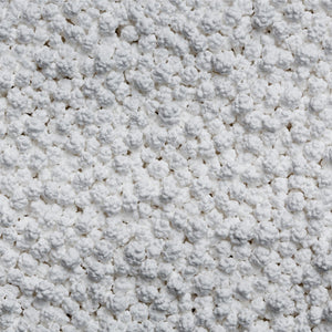 Close-up of the pellets in the Snow Joe Pure Calcium Chloride Ice Melt.