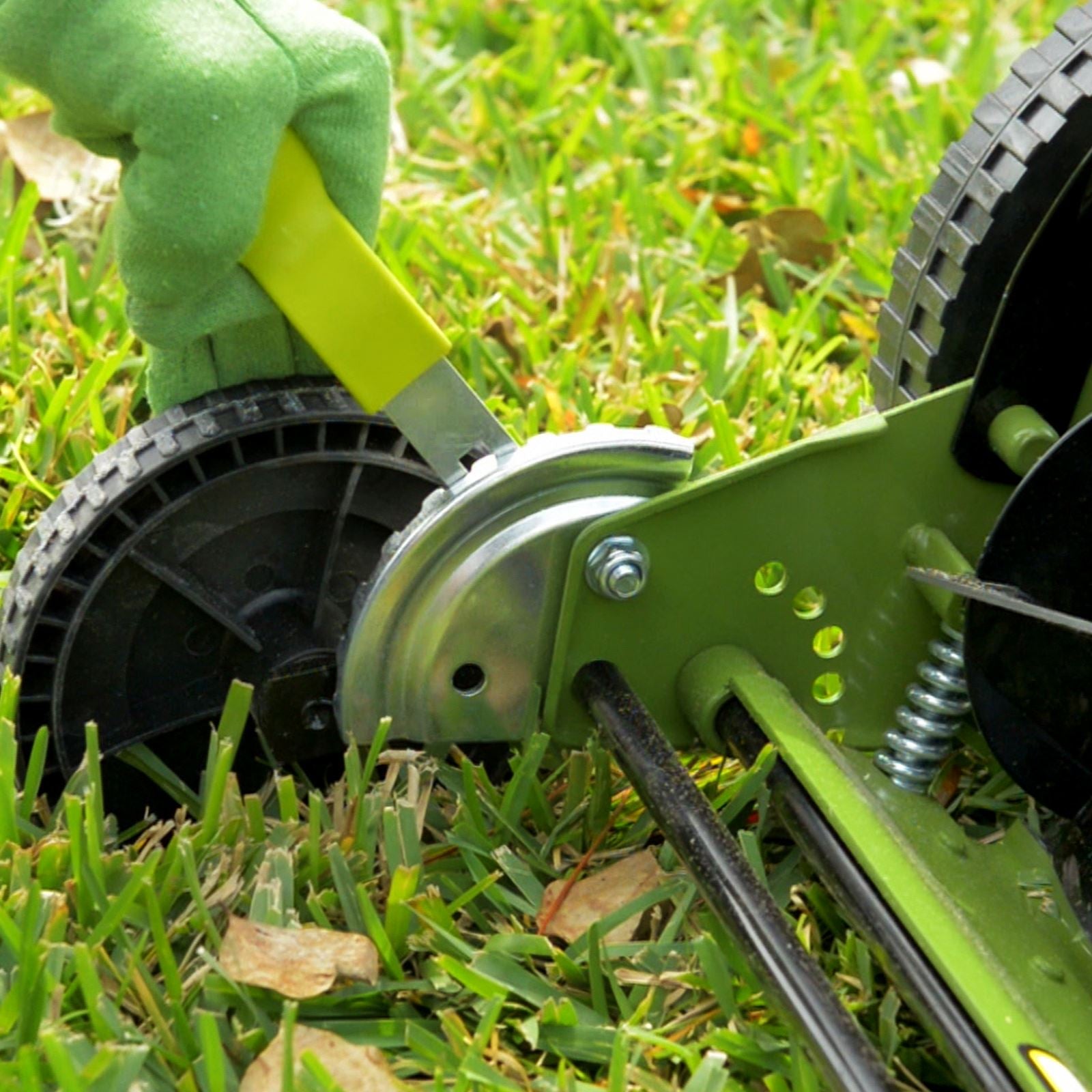 Close-up of the height adjustment lever on the Sun Joe 16-inch manual reel lawn mower.