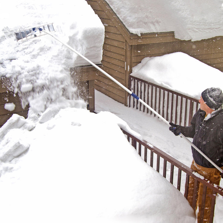 Snow Joe 21-foot aluminum telescoping snow shovel roof rake getting snow off the roof of a house.