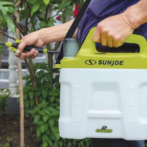 Person holding the Sun Joe 4-volt 2-gallon Cordless All Purpose Chemical Sprayer.