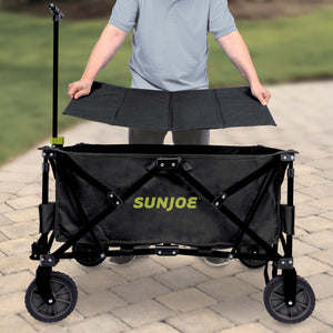 Person putting the base plate into the bottom of the Sun Joe Heavy-Duty Metal Framed Garden Utility Wagon.