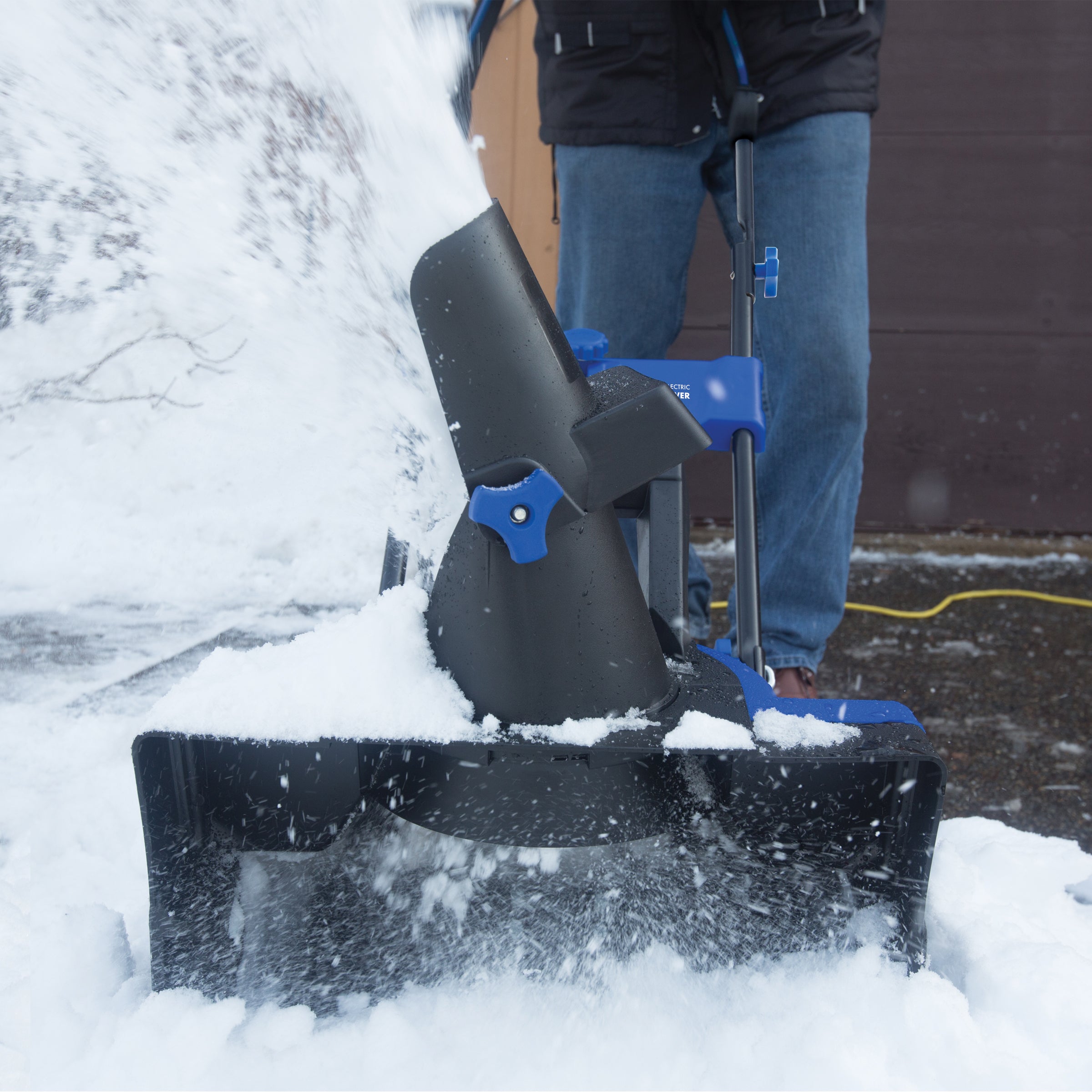 Snow Joe 14-amp 21-inch Electric single-stage snow blower throwing snow.