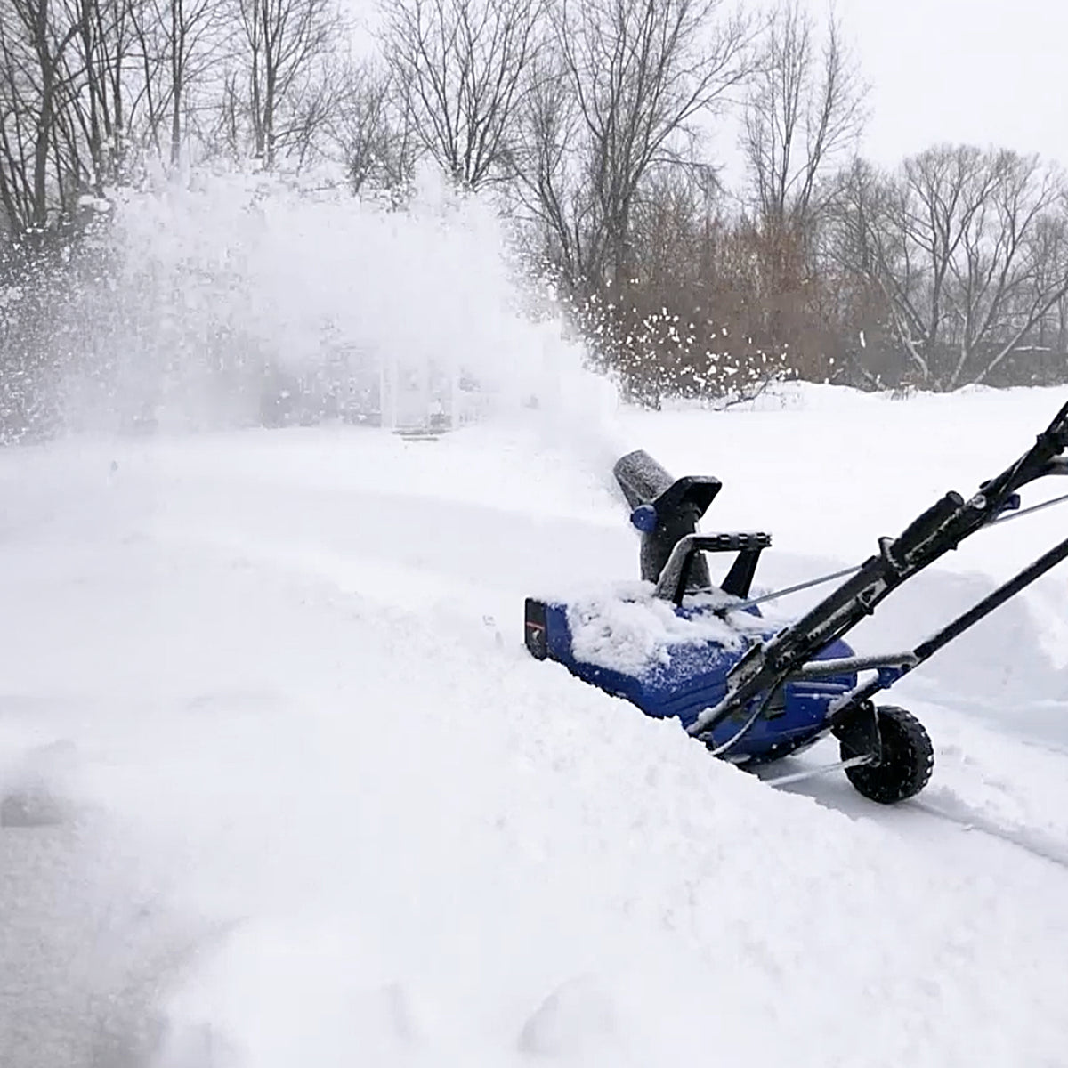 Snow Joe SJ627E shown clearing snow in a manufacturer lifestyle photograph
