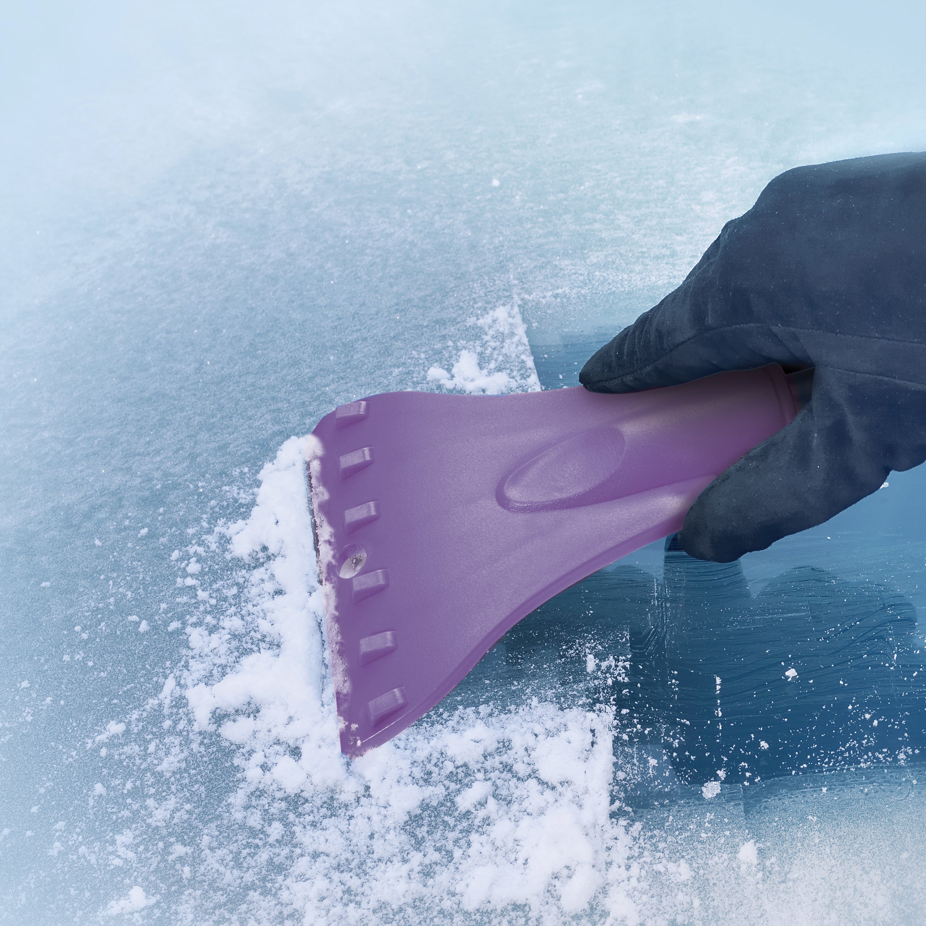 Snow Joe 19-inch 2-In-1 Telescoping purple Snow Broom and Ice Scraper scraping ice off a winddow.