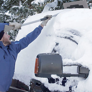 Snow Joe 19-inch 2-In-1 Telescoping gray Snow Broom and Ice Scraper being used to push snow off the top of a car.