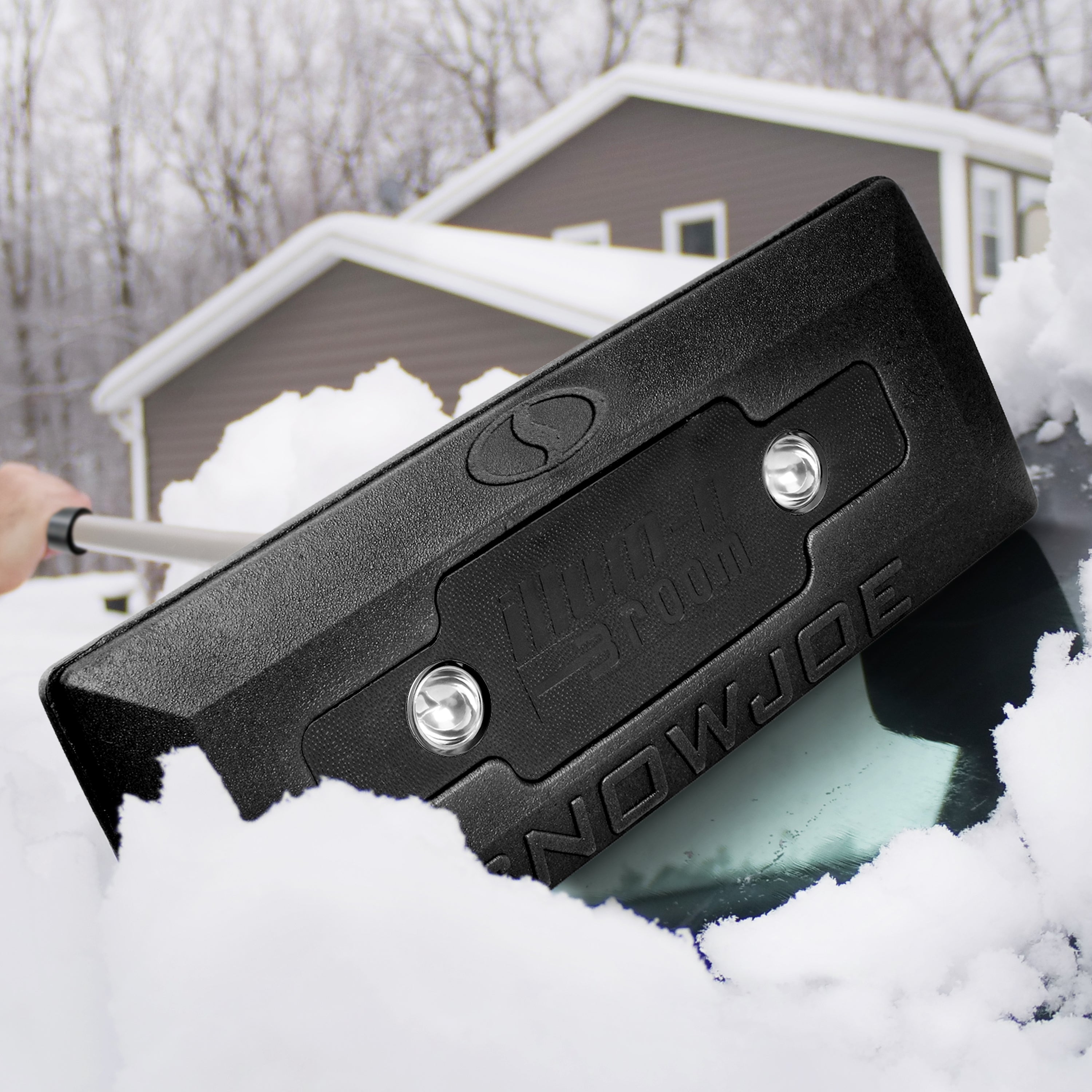 Person using SJBLZD-LED-BLK lighted snow broom to remove snow from their vehicle windshield