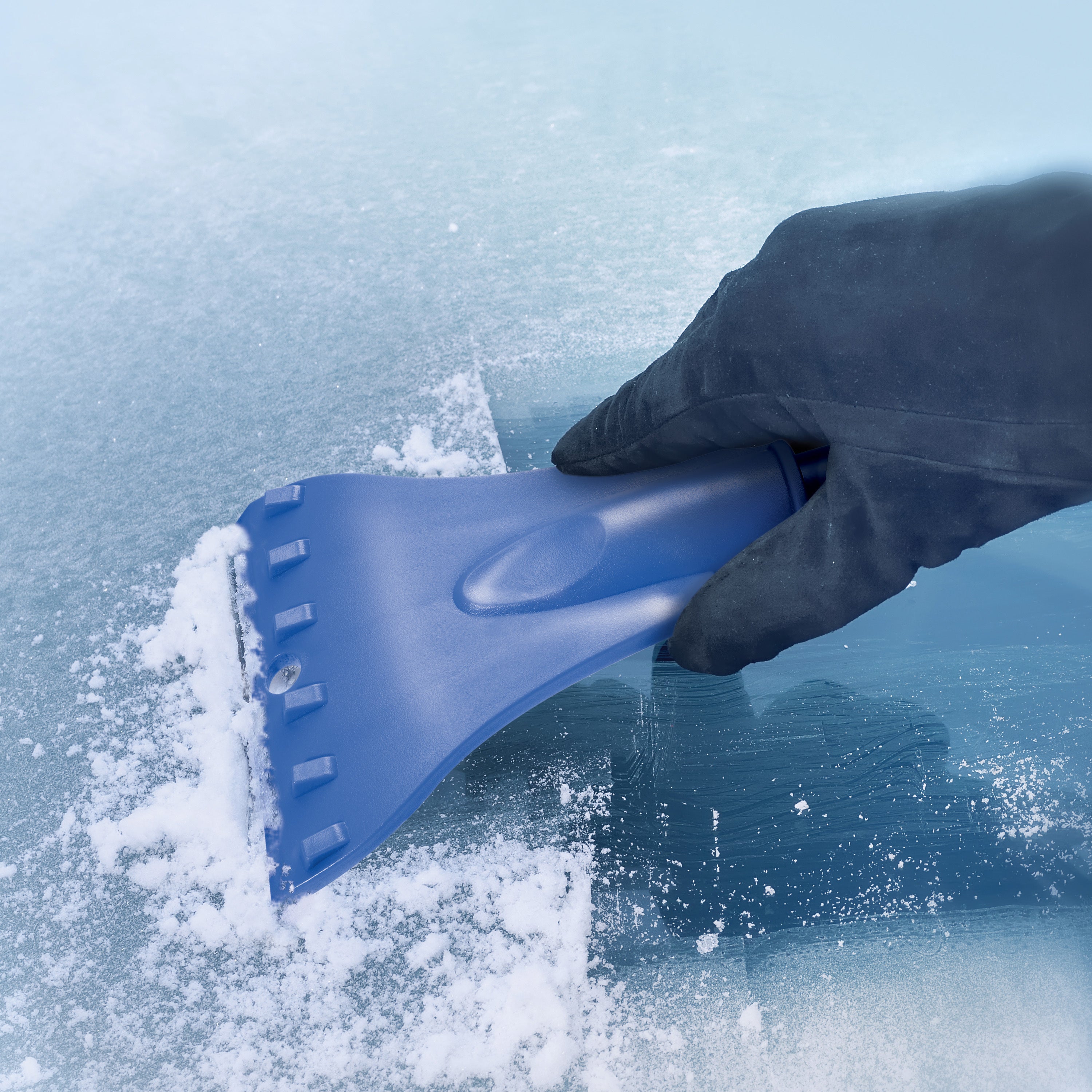 Person using the built-in ice scraper to get ice off their windshield.