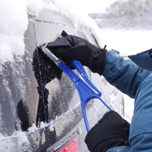 Snow Joe Ice Dozer Ice and Snow Scraper with bristle brush attachment being used to scrape ice off a cars rear window.